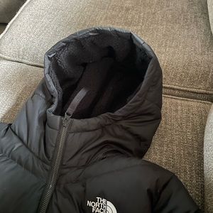 Women’s black North Face winter coat.